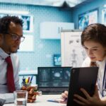 Doctors using eClinicalWorks EMR to review patient scan results in a modern clinical setting.