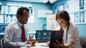 Doctors using eClinicalWorks EMR to review patient scan results in a modern clinical setting.