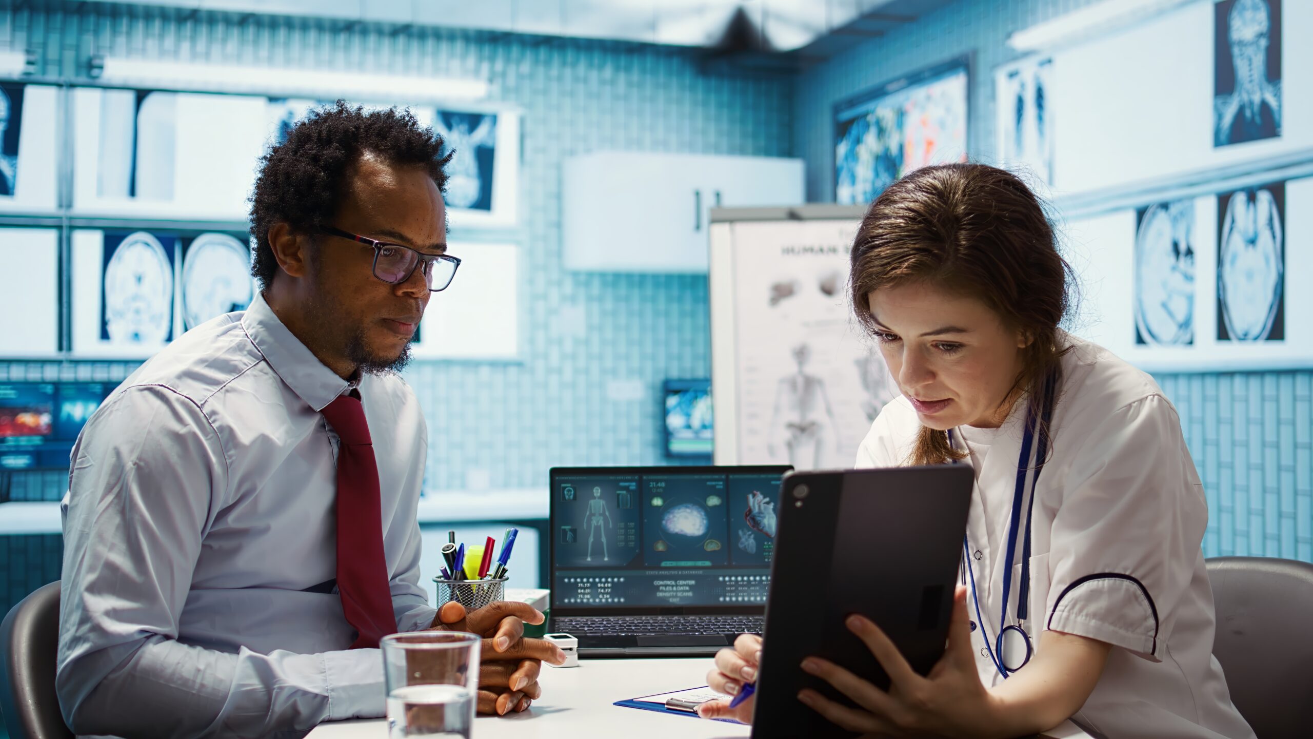 Doctors using eClinicalWorks EMR to review patient scan results in a modern clinical setting.